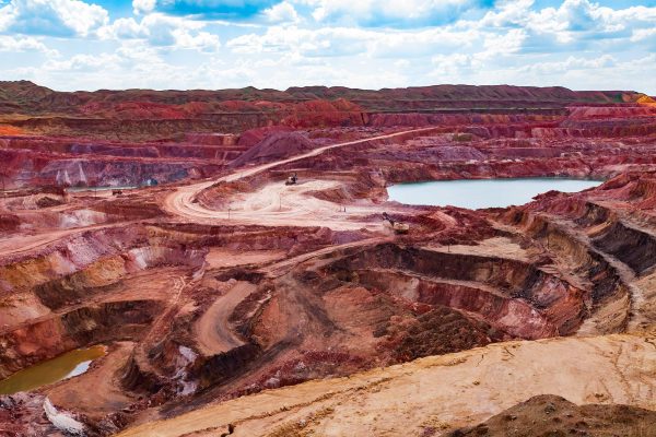 Bauxite mining site supplying alumina refinery for Bayer process production.