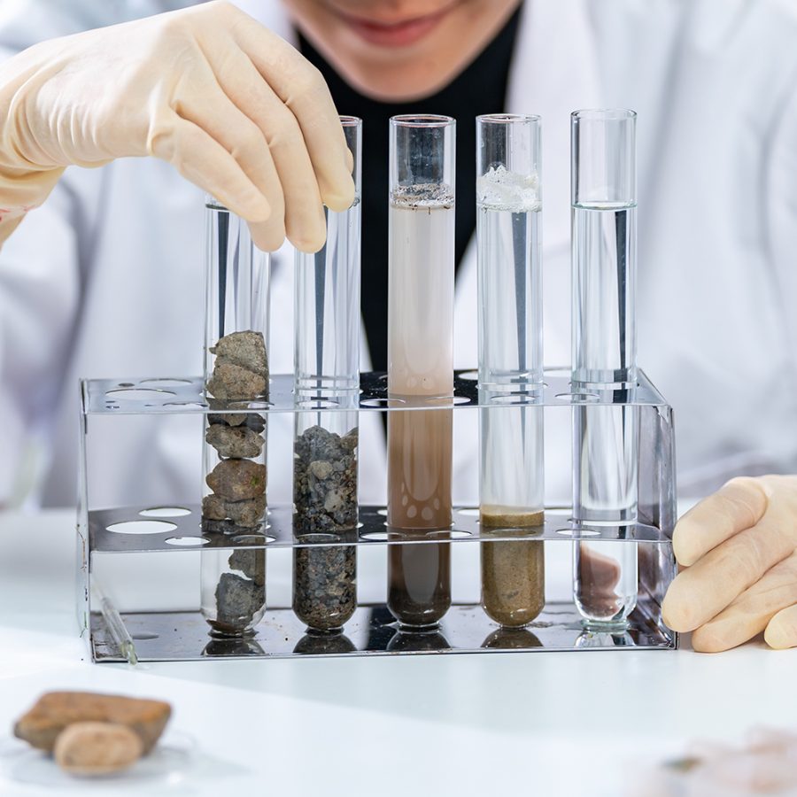 Gold ore laboratory testing with test tubes analyzing slurry behavior and mineral variability in gold processing