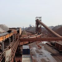 Mining conveyor system and stockpile infrastructure illustrating material handling control from crusher to stockpile.