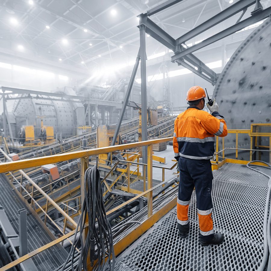 Hydrometallurgy operator monitoring leaching and separation equipment in a metal recovery plant.
