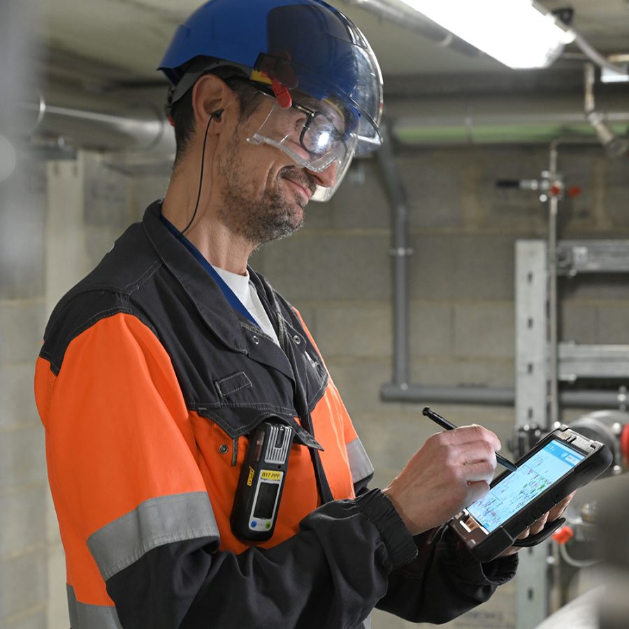 Mining technician monitoring industrial equipment to optimize energy efficiency and process stability.