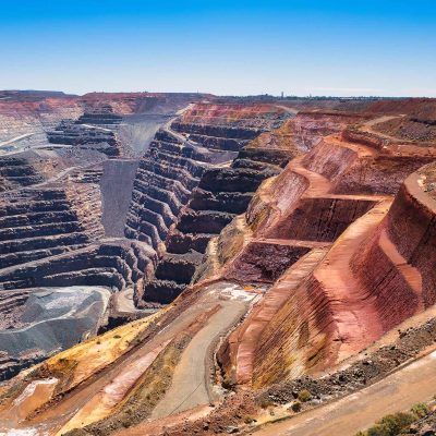 Open-pit gold mine with haul road illustrating modern gold processing operations and recovery challenges