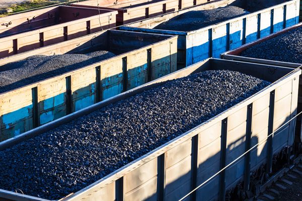 Rail wagons loaded with wet ore treated to prevent freezing and sticking.