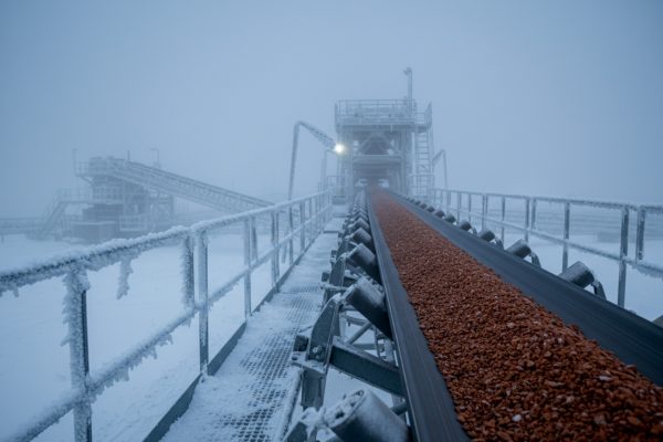 Cold-weather ore handling on conveyor belt protected with freeze control agent.